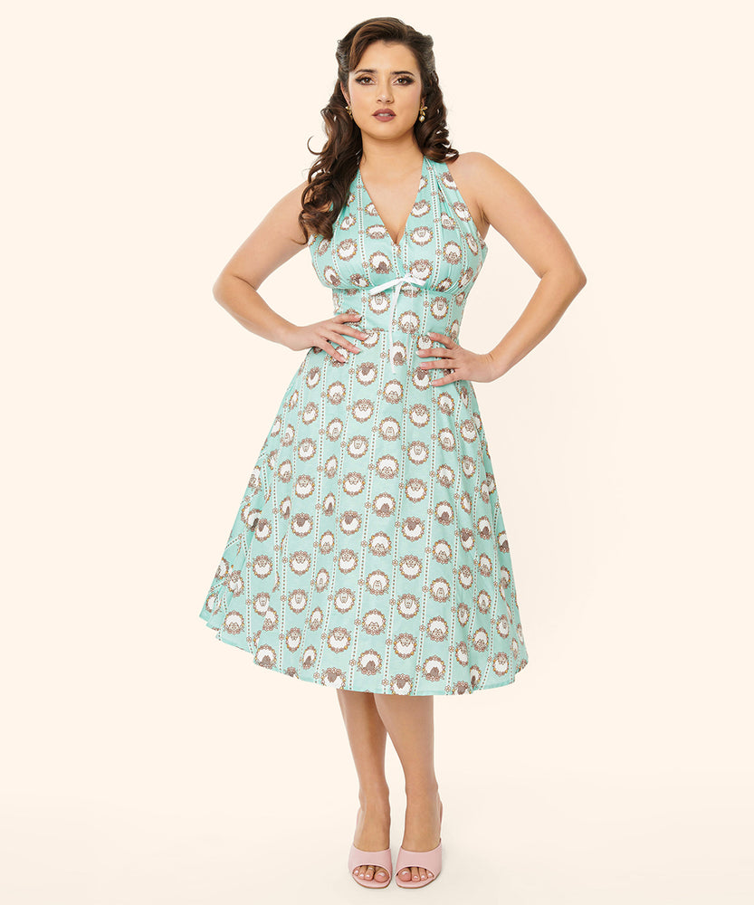Model poses in the Springtime Halter Dress featuring Pusheen, Pip, and Stormy. The dress has portrait prints running vertically down the dress.