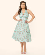 Model poses in the Springtime Halter Dress featuring Pusheen, Pip, and Stormy. The dress has portrait prints running vertically down the dress.