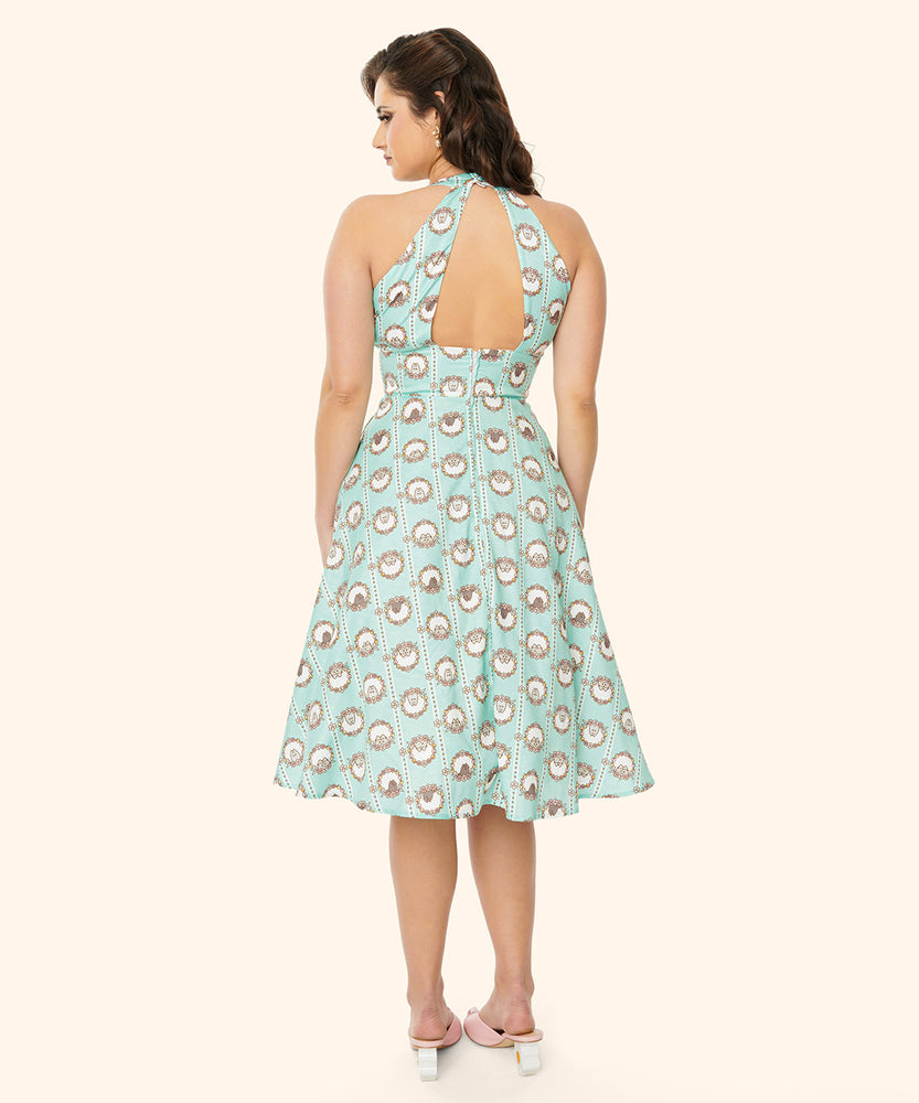 Back view of the model wearing the Pusheen Halter Dress. Beneath the halter top, the dress has an align silhouette that falls below the wearer's knees.