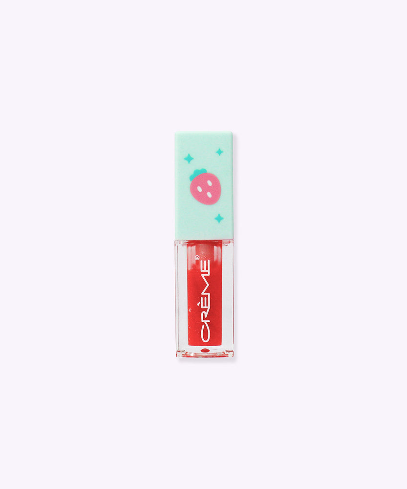 Back view of the Twinkle Star Pusheen Lip Oil. The mint green lid has a printed pink strawberry and green sparkles on the topper.