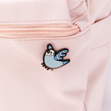 The Bo pin attached to a pink backpack.