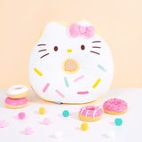 Front view of Hello Kitty side of Hello Kitty x Pusheen Donut Plush. The double-sided donut inspired plush showcases Hello Kitty as a white glazed donut with multicolor blue, pink, and yellow sprinkles. Hello Kitty is accompanied by her classic pink bow. Plush is surrounded by pink and white donut figurines and multicolor poms.  