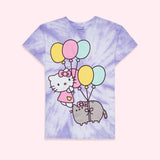 A short sleeve light purple and white tie dye shirt laid out flat on top of a light pink surface. In the center of the unisex shirt is a large graphic of Hello Kitty and Pusheen floating with yellow, pink, and blue balloons.