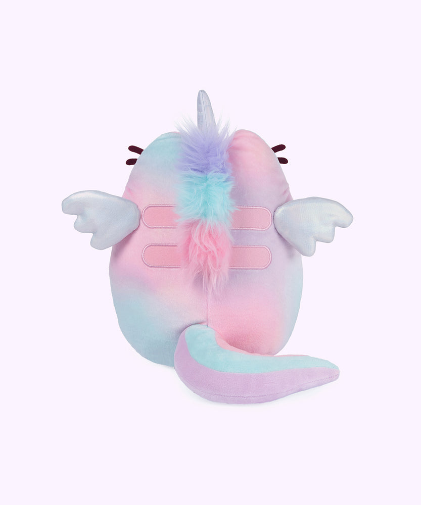 Back view of the Magic Swirl Pusheenicorn. Pusheen’s iridescent horn and wings are accented by her whiskers that can be seen on the sides. The tie-dye plush has fur down the back and striped multi-color tail. 