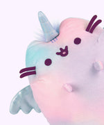Closeup view of the tie-dye plush. In this view you can see fur coming out the back of the plush and a more detailed view of the color variation in the body of the plush. 