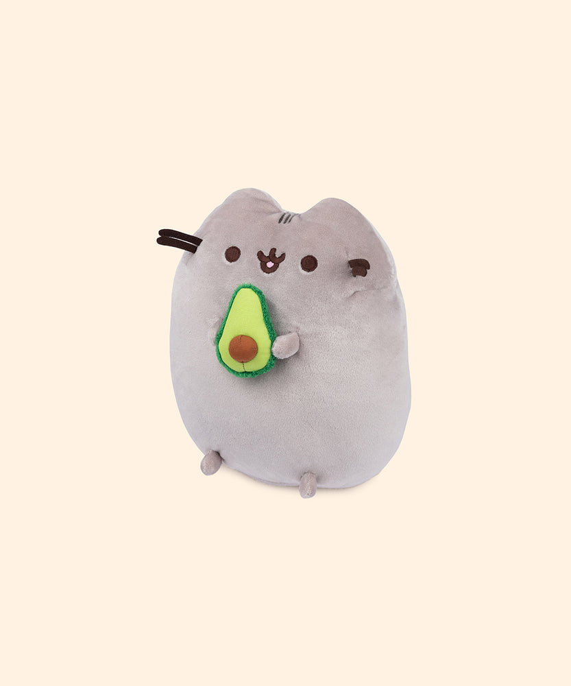Left quarter view of avocado plush. This view shows Pusheen’s feet extending slightly off her body and the dimensions of the cut-in-half avocado.