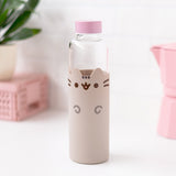 Front view of Pusheen Glass Water Bottle. Glass water bottle has a silicone sleeve that covers ¾ of the bottle for protection. The grey sleeve features Pusheen the Cat with dark grey and brown details including eyes, whiskers, mouth, head stripes, and front paws. 