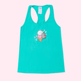 A light teal graphic ladies tank lays against a light pink background. The graphic in the center of the tank top features Pusheen the Cat climbing on a white, pink, and yellow ice cream cone. 