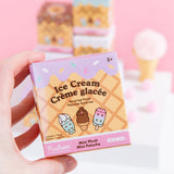 A close-up of the Pusheen Ice Cream Surprise Plush packaging. The front of the packaging has an ice cream cone inspired background with icing, sprinkles, and Pusheen Ice Cream characters in the foreground. The packaging says that these Surprise Plush are mini plush. 