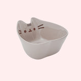 Right top view of the Pusheen Ramen Bowl. & Chopstick Set. The Pusheen shaped bowl has Pusheen's classic facial features and paws printed inside the interior of the bowl for a fun reveal once through with a meal. 