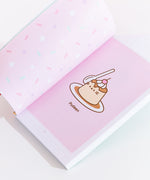 The interior of the book, showing off a "Pudeen" comic with Pusheen taking the shape of a Flan dessert. On the left page is multi-colored sprinkles print.
