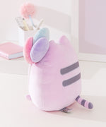 Side and back view of the Birthday Pusheen Plush. Pusheen's classic back stripes are embroidered in gray while her tail is purple and gray striped.