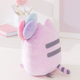 Side and back view of the Birthday Pusheen Plush. Pusheen's classic back stripes are embroidered in gray while her tail is purple and gray striped.