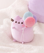 One of the light purple cat paws holds a trio of mint green, pink, and lavender colored balloons. 