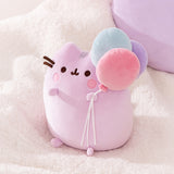 One of the light purple cat paws holds a trio of mint green, pink, and lavender colored balloons. 