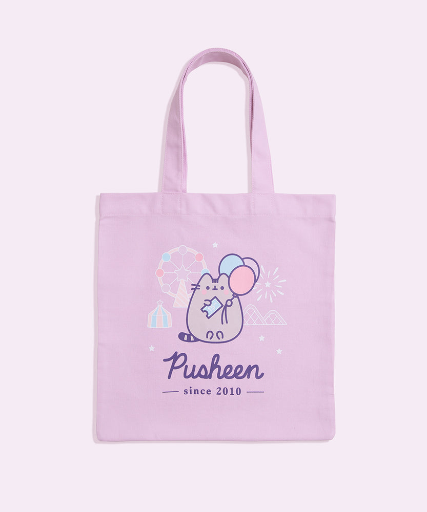 A purple canvas bag with pink, blue, purple, white, and grey, printed graphic ties on a flat background.