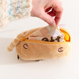 Nylon bag folded into a yellow plush rectangular container.