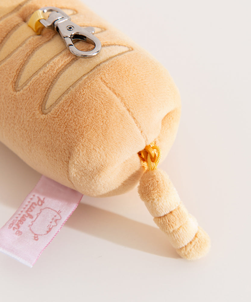 Close-up view of yellow zipper on the bottom of the keychain plush.