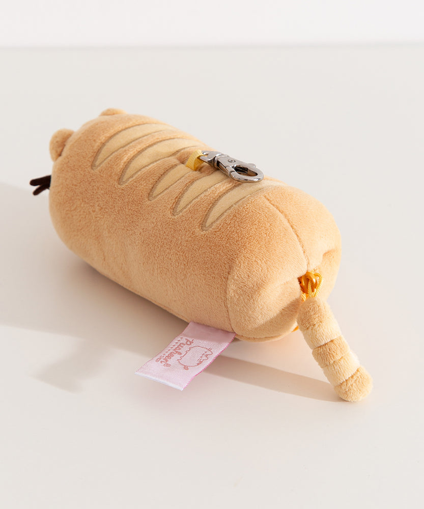 Back view of the baguette shaped plush keychain. The bottom zipper has Pusheen the Cat's striped tail attached. 
