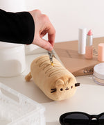 Model holds the lobster claw keychain that attaches to the top of the baguette plush bag holder. 