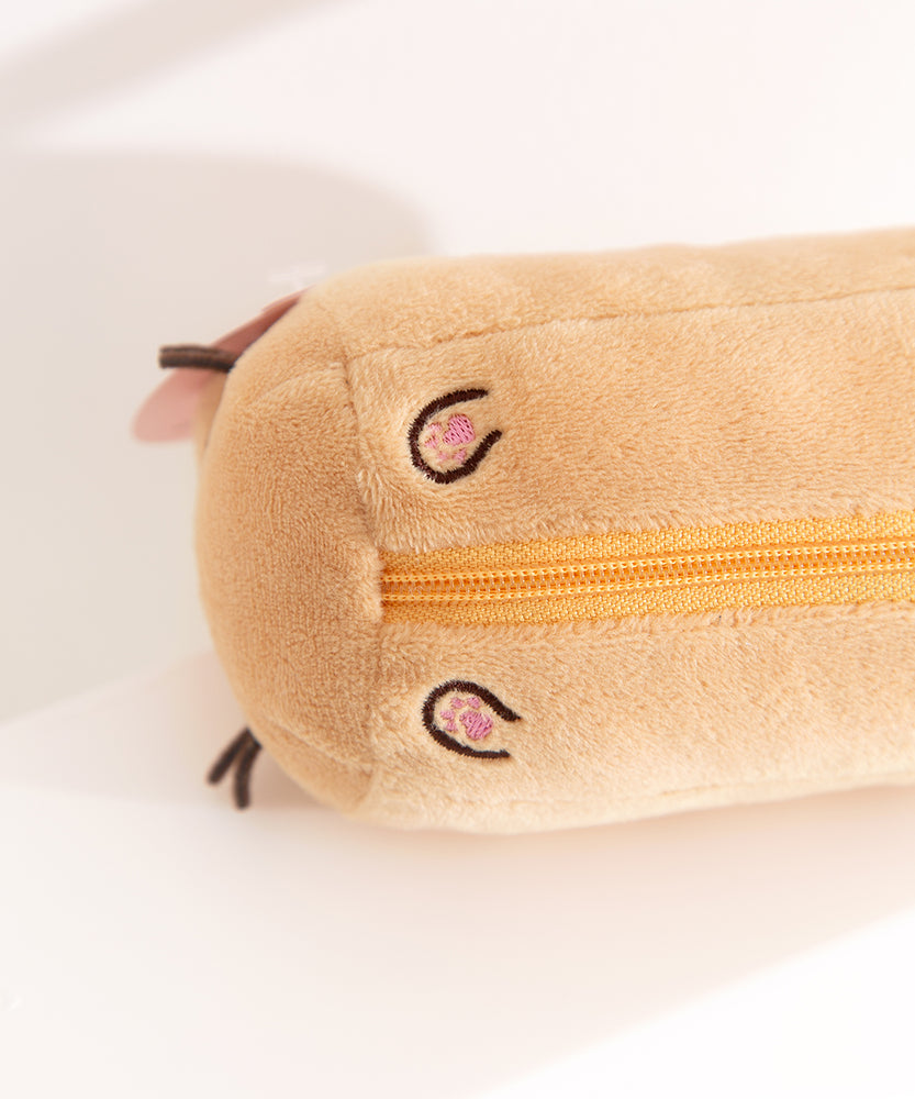 Close-up view of the tiny embroidered paws on the bottom of the keychain bag plush.