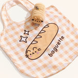Yellow gingham nylon tote bag lies on a surface with the yellow baguette bag keychain holder. 