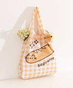 Nylon bag and storage keychain plush bag sat upright on a white background.