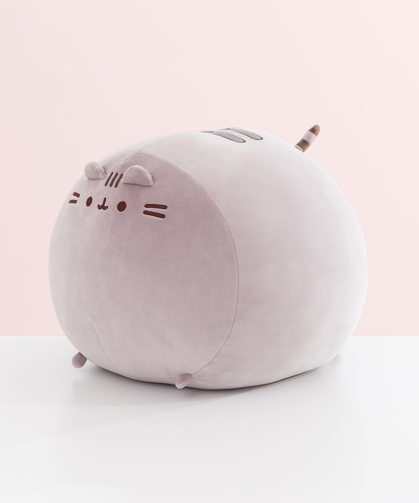 Other side view of the Big Mochi Squisheen Plush. Pusheen's facial features, two back stripes, and striped tail are near the top of the plush while the paws are attached at the bottom of the plush.