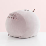 Other side view of the Big Mochi Squisheen Plush. Pusheen's facial features, two back stripes, and striped tail are near the top of the plush while the paws are attached at the bottom of the plush.