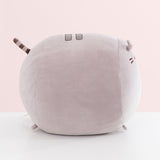 Side view of the grey cat plush. The rounded shape has a slightly flatter front face to showcase Pusheen's face.