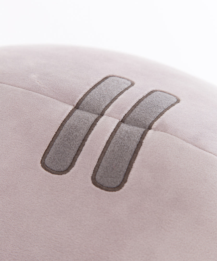 Close-up of the embroidered stripes on the very top of the plush. The two stripes have a light grey interior and a darker grey embroidered outline.