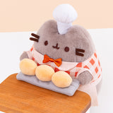 Top aerial view of BakerPusheen plush to show off Pusheen’s three biscuit buns that are a creamy yellow color.  Image includes the text "*countertop not included" in top left corner of image.