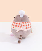 Back view of Baker Pusheen Plush. The checkered top and apron combo are tied in the back with a bow. Pusheen’s gray striped tail is seen coming off the bottom back of the plush. 