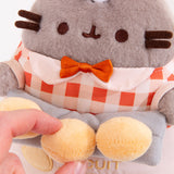 Close-up view of the light-yellow buns that Pusheen holds. Model holds one biscuit to show that the buns are attached to the plush. 