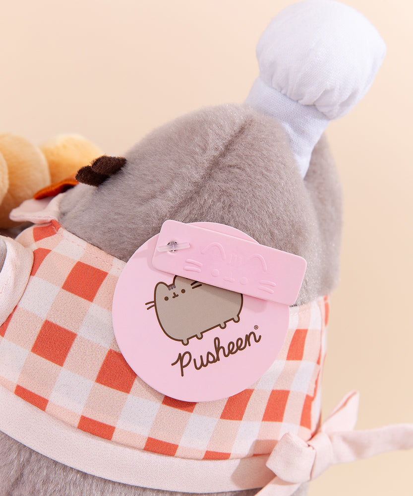 Close-up view of light pink Pusheen logo tag and embossed Pusheen Label tag. 