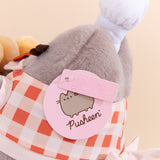 Close-up view of light pink Pusheen logo tag and embossed Pusheen Label tag. 