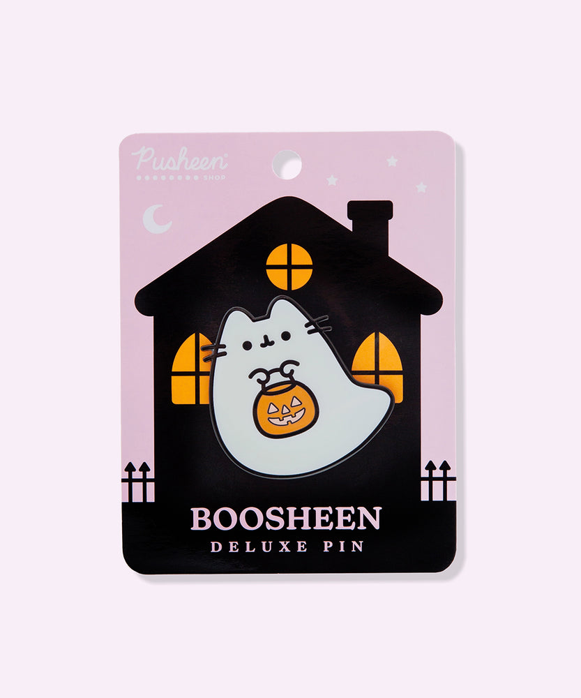 Boosheen Deluxe Pin on backer card. The backing card depicts a haunted-looking black house with orange light peeking through the three windows. The backer card is light purple. 