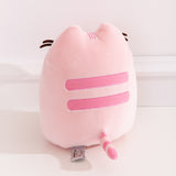 Back view of the Pusheen Sweets Cherry Macaron Squisheen. The light pink plush has two embroidered medium pink stripes along the back. The striped tail extending off the bottom of the plush features the same light pink and medium pink colors alternating.