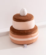 Back view of the Chocolate Cake plush. The large two-tiered cake plush has brown icing on each tier.