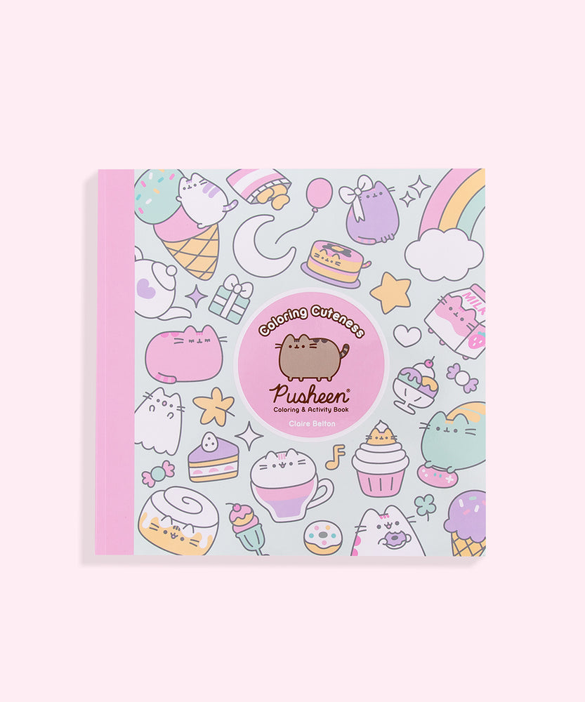 Front cover of the Coloring Cuteness: A Pusheen Coloring & Activity Book. The front cover includes graphics of food items and Pusheen the Cat in various forms including a cupcake, a ghost, a cinnamon roll, a pancake stack, a carton of strawberry milk, and more. In the center of the cover is a pink circle outlined in white that states the title of the book and the author, Claire Belton. The spine of the book is light pink and the background graphic color is light pink.