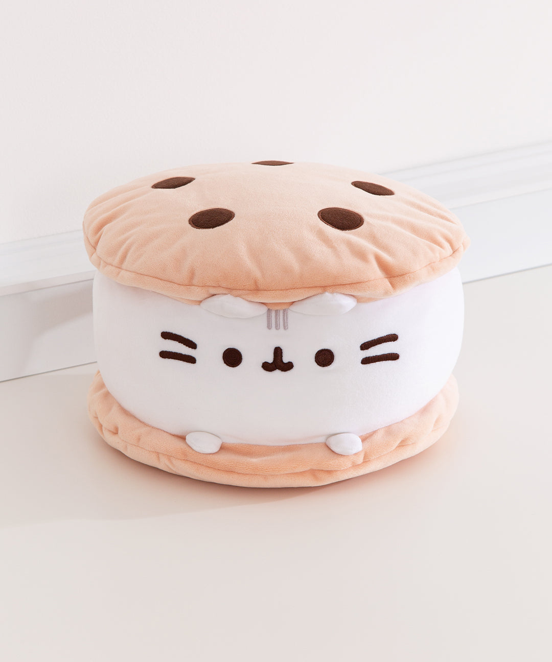 Front view of the Cookie Ice Cream Sandwich Squisheen Plush. The round plush resembles a tasty chocolate chip cookie ice cream sandwich with vanilla ice cream.