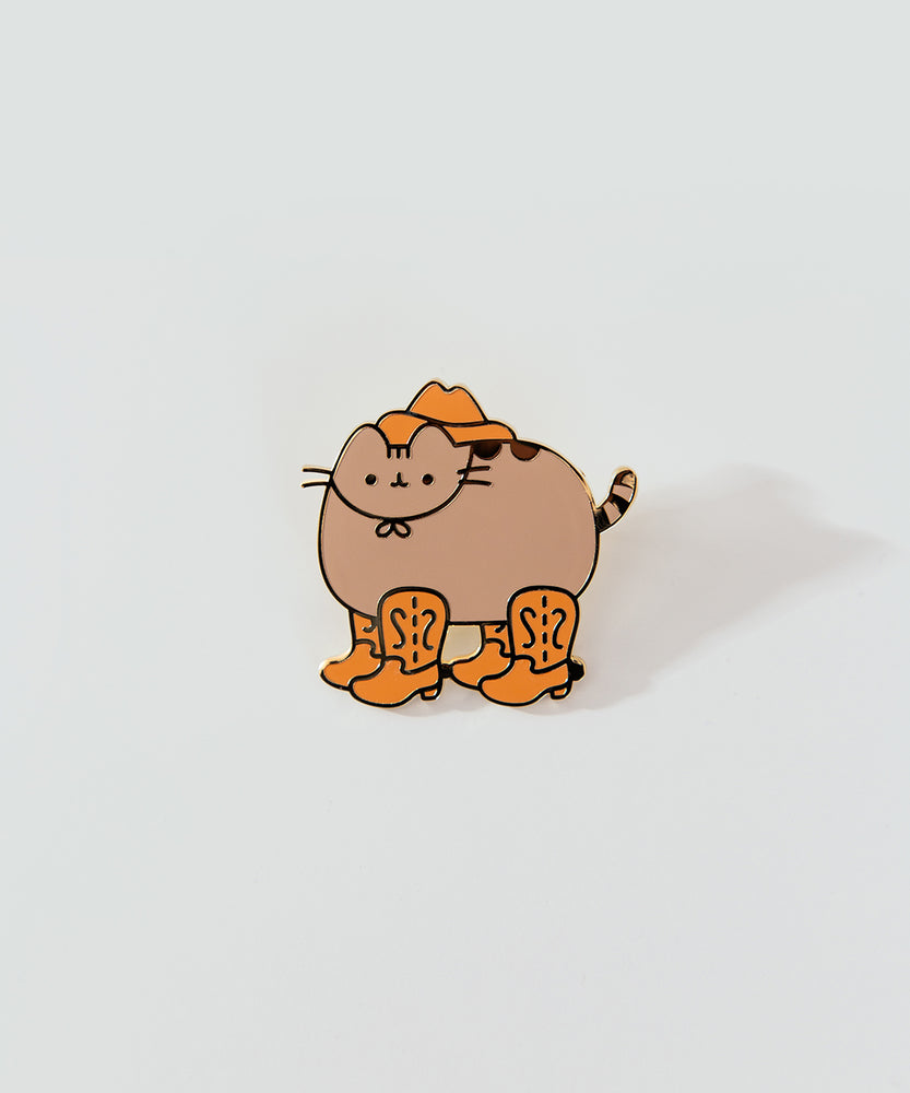 Close-up of Cowboy Pusheen Pin. Pusheen wears a brown cowboy hat and four cowboy boots on her four paws.