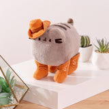 Quarter side view of the Pusheen plush. Pusheen's four paws are wearing cowboy boots.