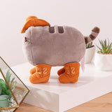 Side view of the fuzzy grey cat plush. Pusheen's striped tail extends off the back of the plush with a slight curve.