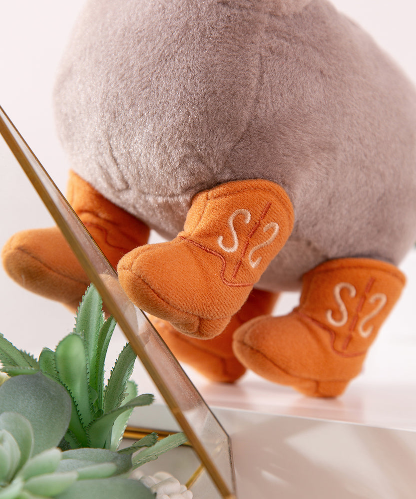 Close-up of the four cowboy boots that Pusheen the Cat wears. The plush stands on the cat's four paws. 