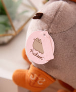 Close-up view of light pink Pusheen logo tag and embossed Pusheen Label tag.