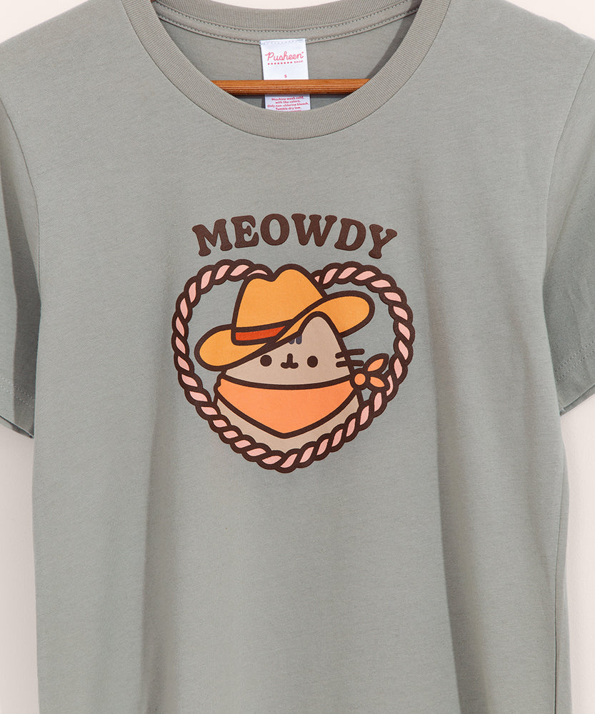 Close-up view of cowboy graphic tee. The phrases above Pusheen graphic in brown colored font is "Meowdy"