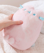 Model strokes Pink Dreamsheen Plush's fabric to show the super soft texture of the Pusheen Plush.