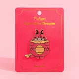 Front view of the Pusheen Year of the Dragon Deluxe Pin. Pusheen the cat wears a red and gold dragon costume. The grey, red, and gold pin has gold plating outlines and is held in the center of a red and gold backer card.