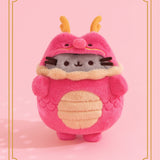 Pusheen Year of the Dragon Plush in front of a light pink background. The red plush is surrounded by a two-striped gold border.